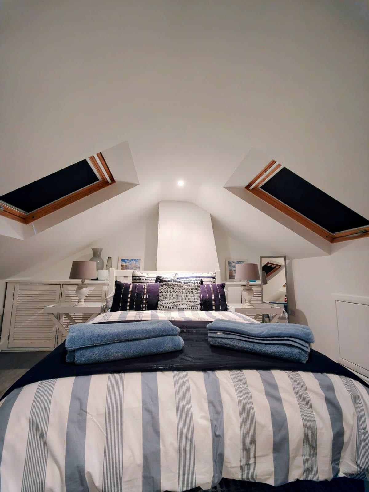 Twin Velux blackout blinds in an attic bedroom