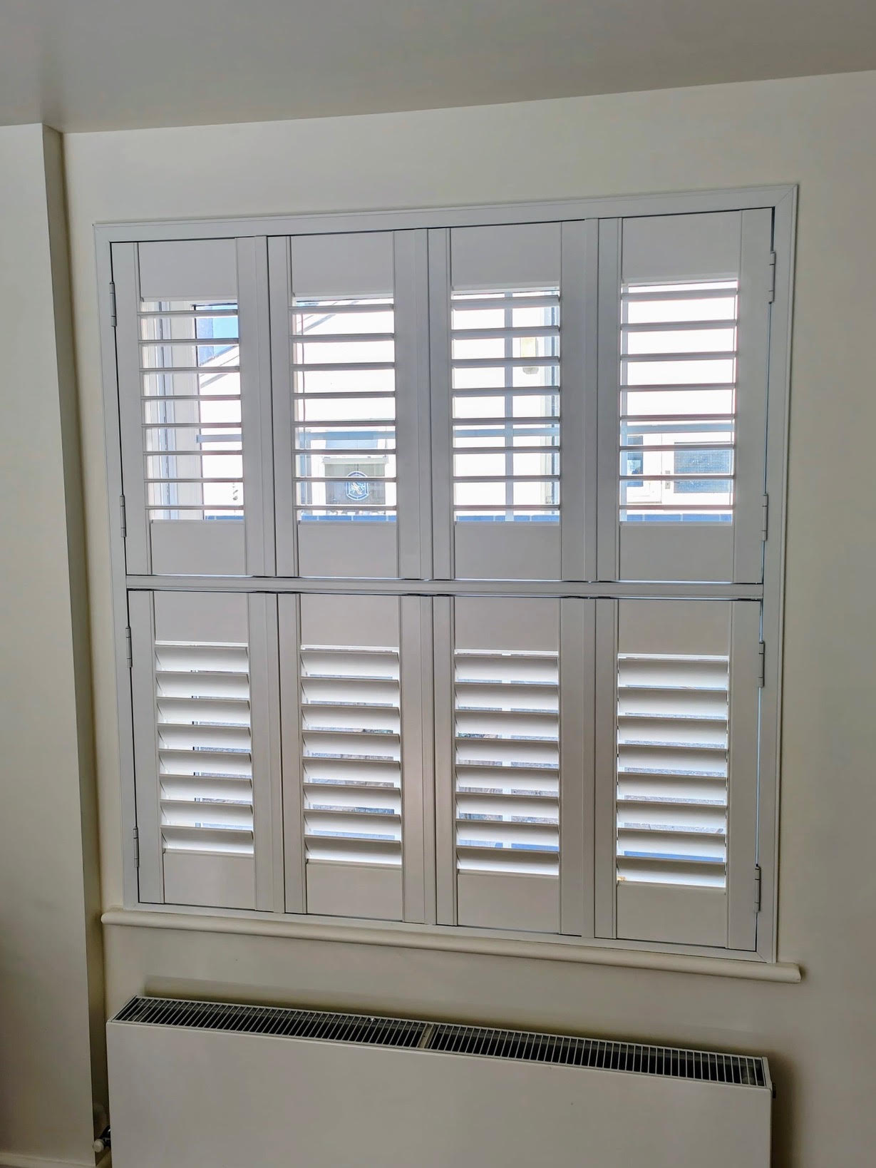 White Tier-on-Tier shutters with the top tier open for daylight