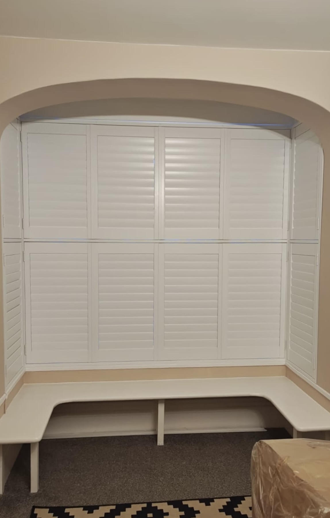 Tier-on-Tier shutters fitted into an arched bay window recess