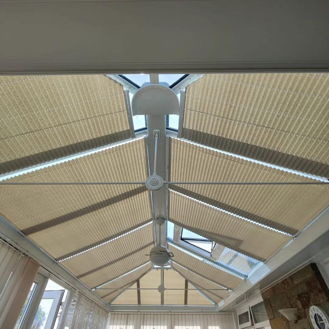 Neutral pleated blinds fitted throughout a conservatory roof