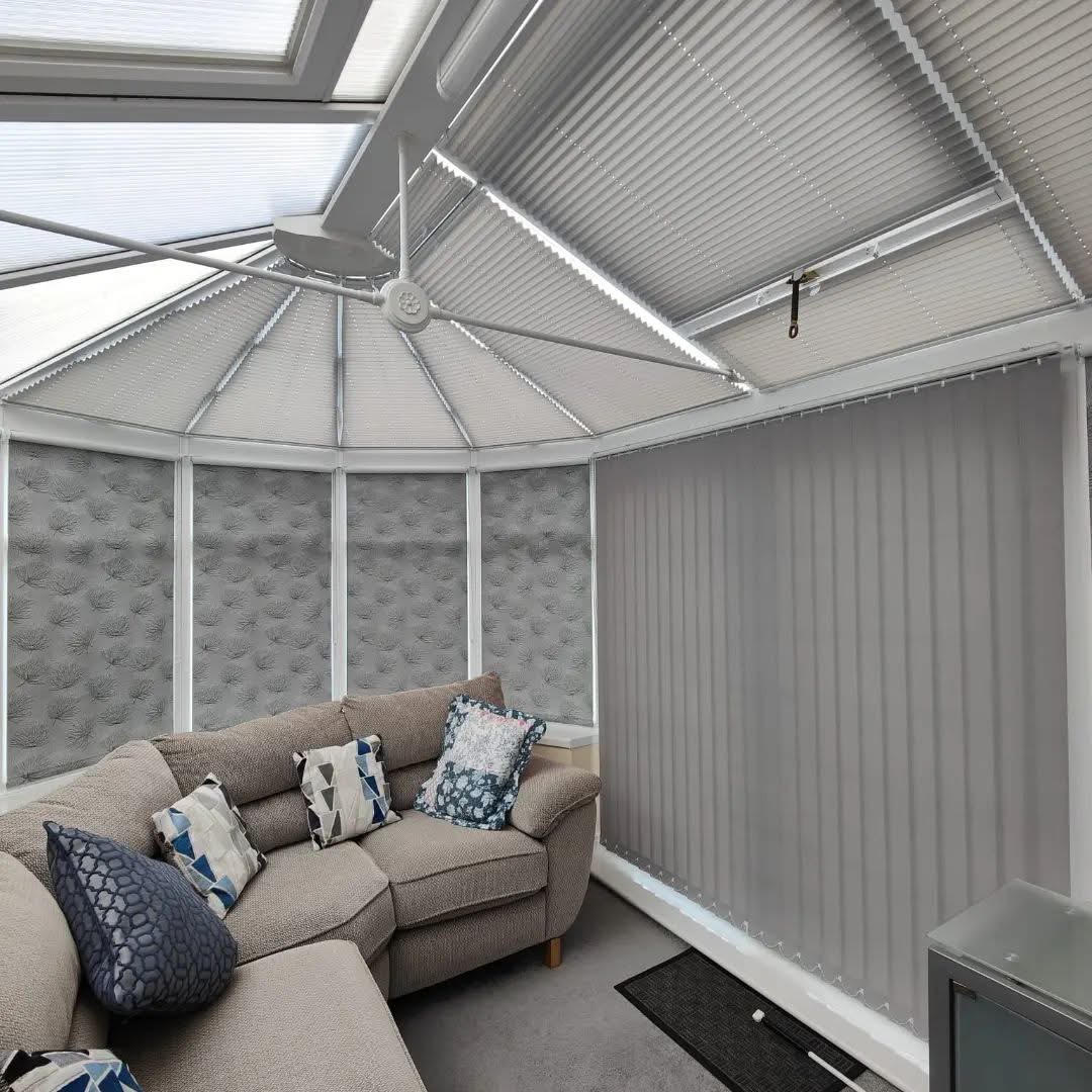 Grey pleated conservatory roof blinds with vertical blinds to the sides
